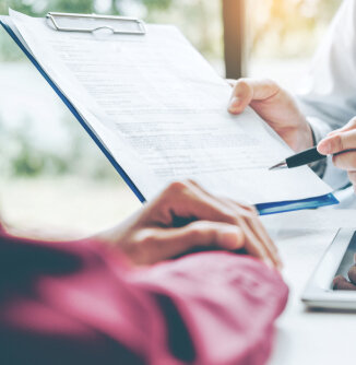 Doctor showing patient a clipboard Doctor showing patient a clipboard
